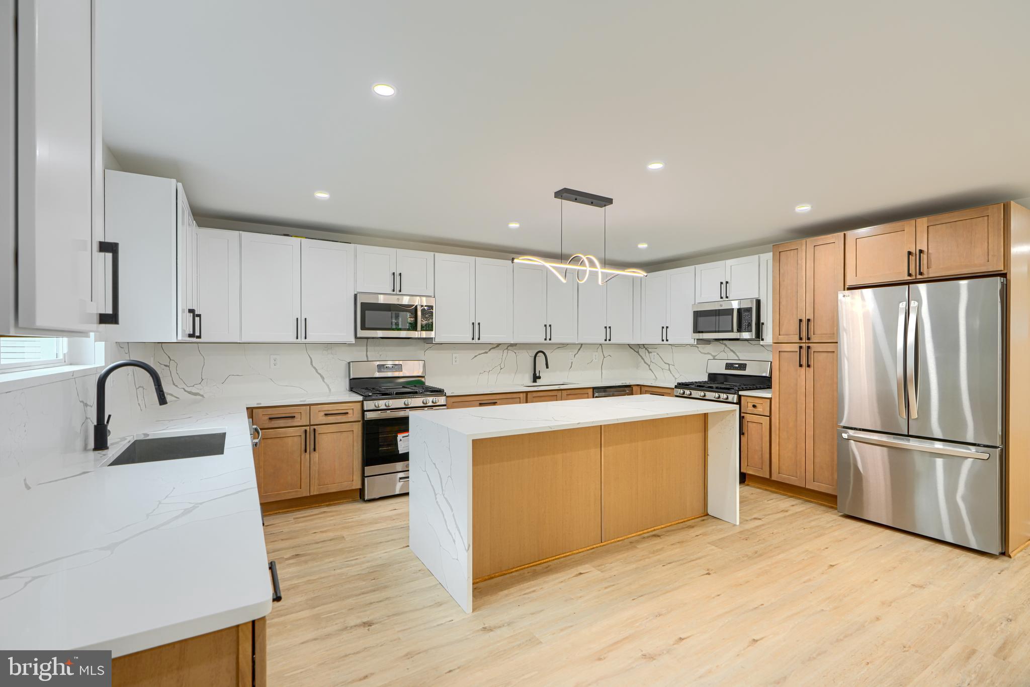 3410 Pinkney Road Baltimore, MD 21215 - Photo 2 of 55 a kitchen with stainless steel appliances granite countertop a refrigerator a stove a sink and a microwave