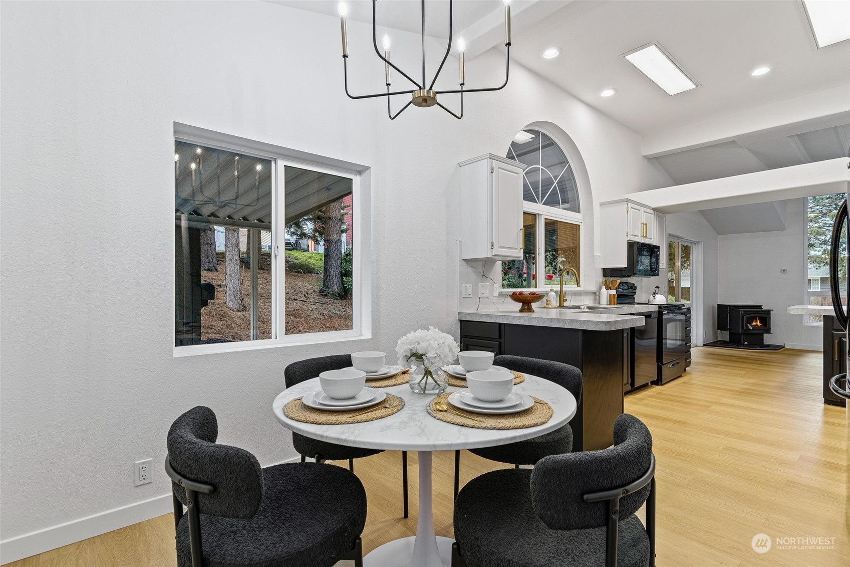 9601 South 198th Place Renton, WA 98055 - Photo 16 of 38 a view of a dining room with furniture and a chandelier