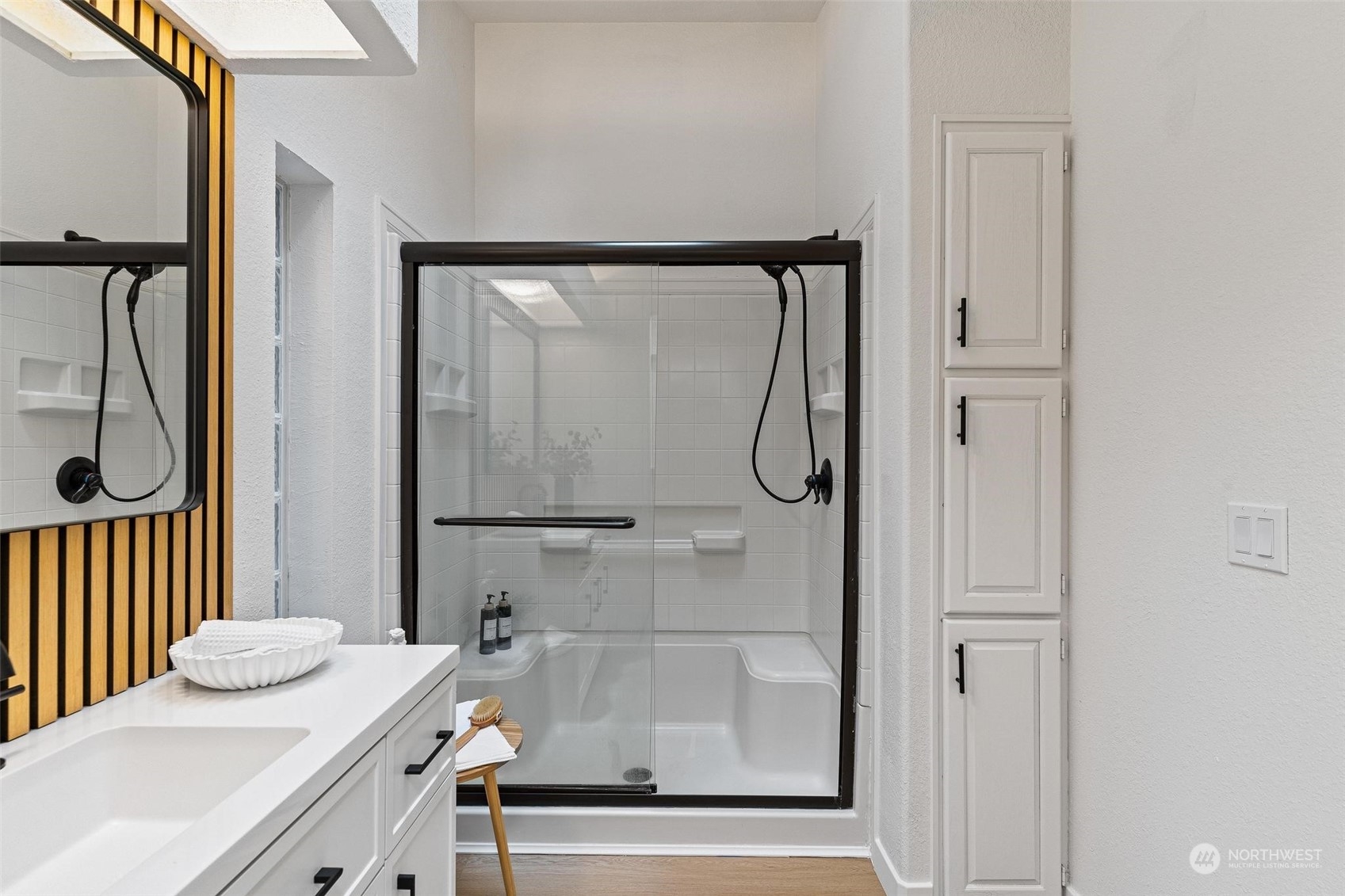 9601 South 198th Place Renton, WA 98055 - Photo 21 of 38 a bathroom with a granite countertop sink a mirror and a shower