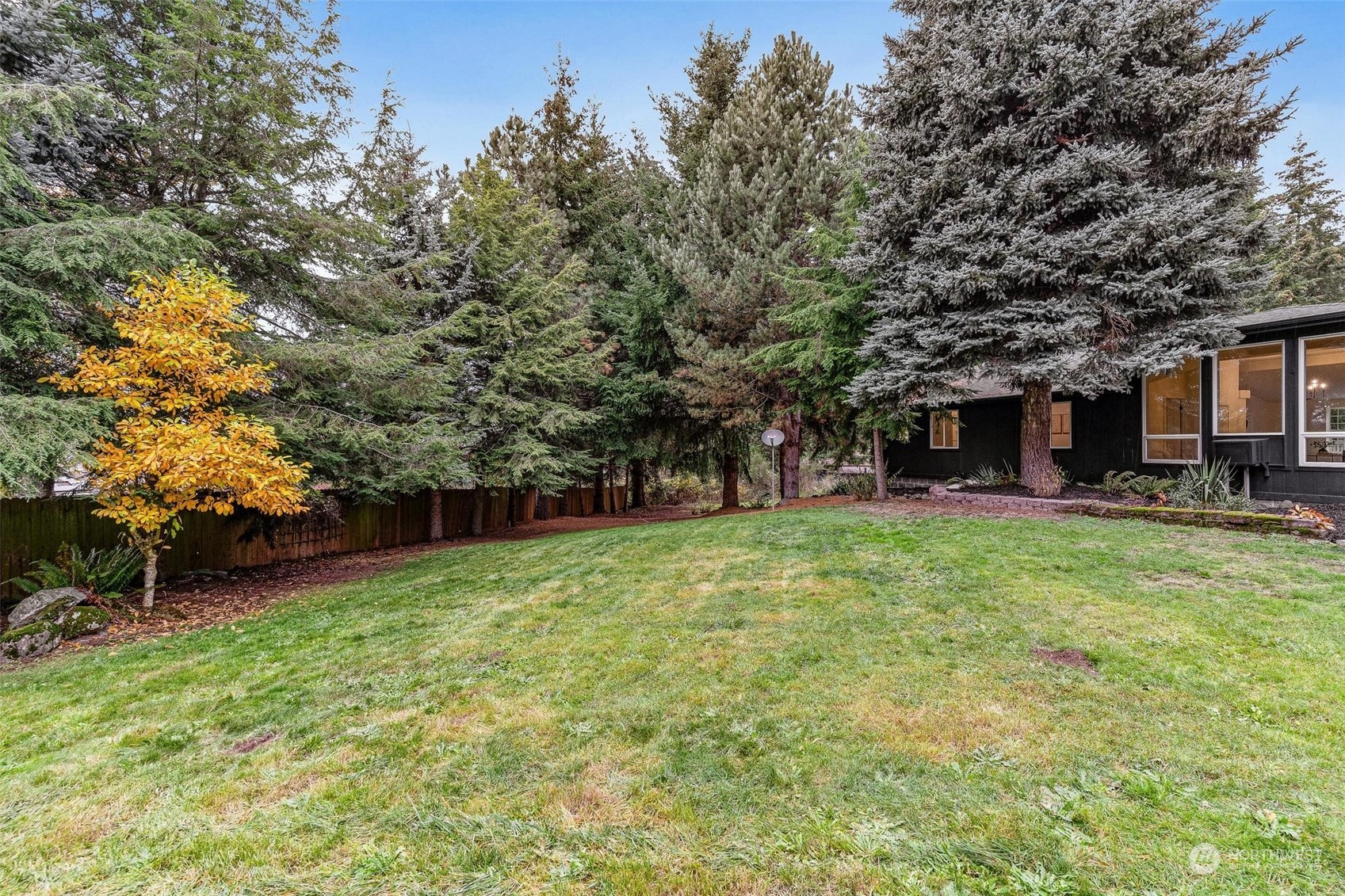 9601 South 198th Place Renton, WA 98055 - Photo 31 of 38 a backyard of a house with lots of green space