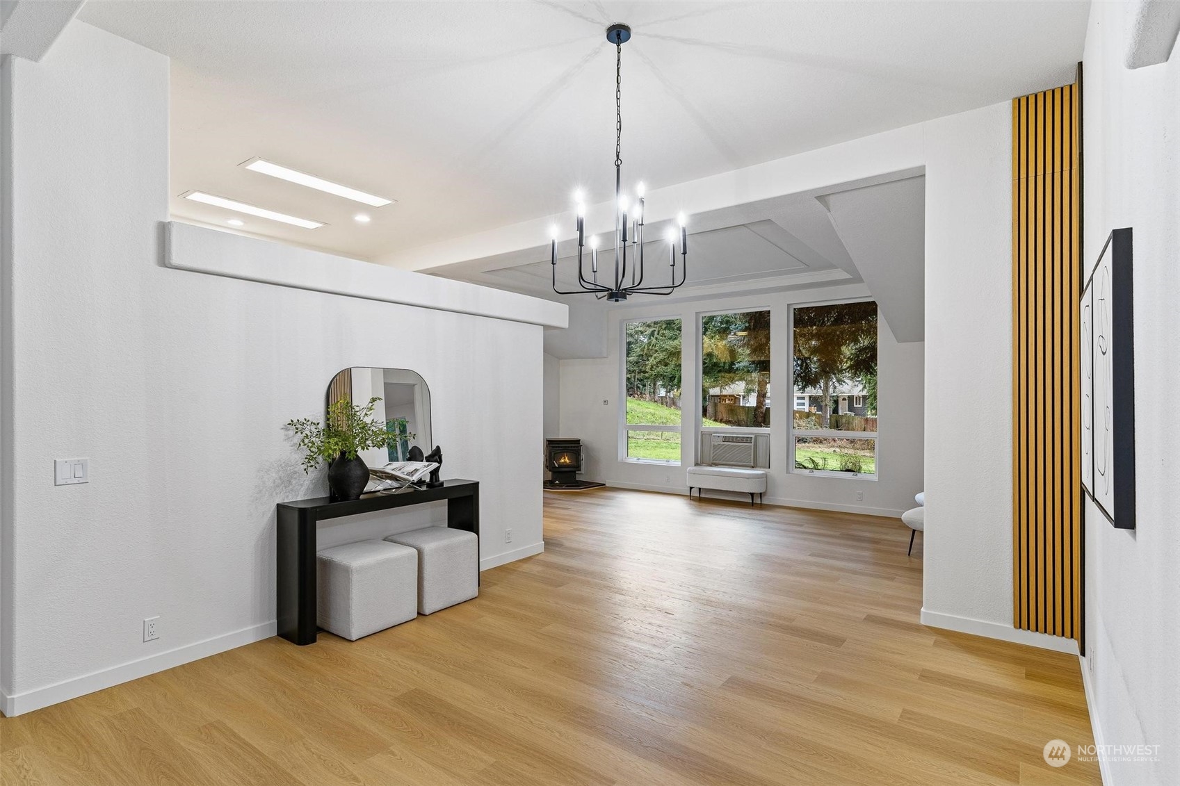 9601 South 198th Place Renton, WA 98055 - Photo 7 of 38 a view of a hallway with wooden floor and a chandelier