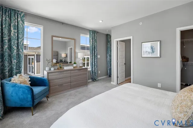 a bedroom with furniture and a large window