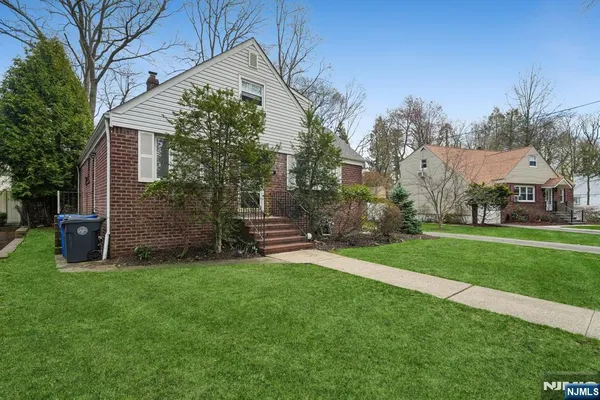 a view of a house with a yard and sitting area