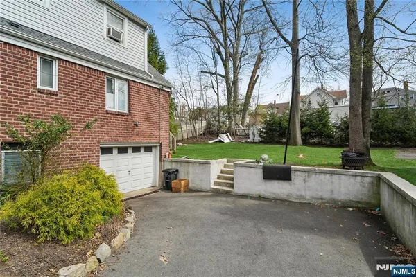 a view of a house with a yard and tree s