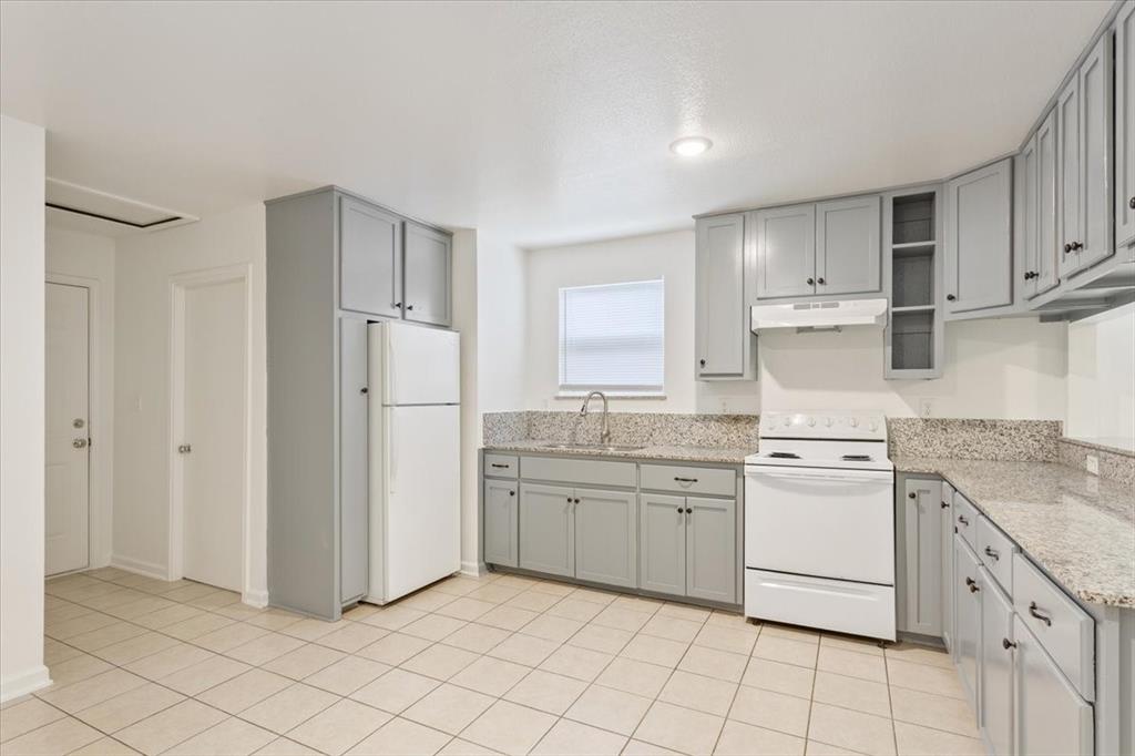 1120 Holt Avenue Waco, TX 76706 - Photo 11 of 25 a kitchen with stainless steel appliances granite countertop a refrigerator and a sink