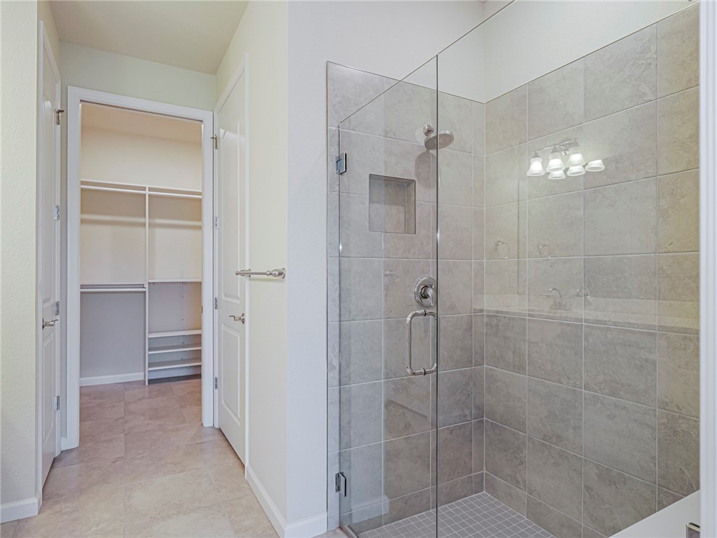 5190 Unity Square Vero Beach, FL 32967 - Photo 19 of 31 a bathroom with a shower and a glass door