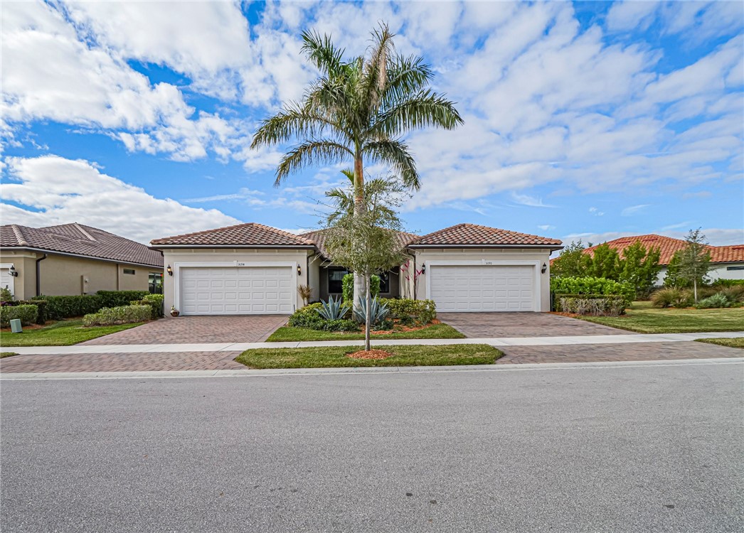 5190 Unity Square Vero Beach, FL 32967 - Photo 2 of 31 a view of a house with a yard and garage