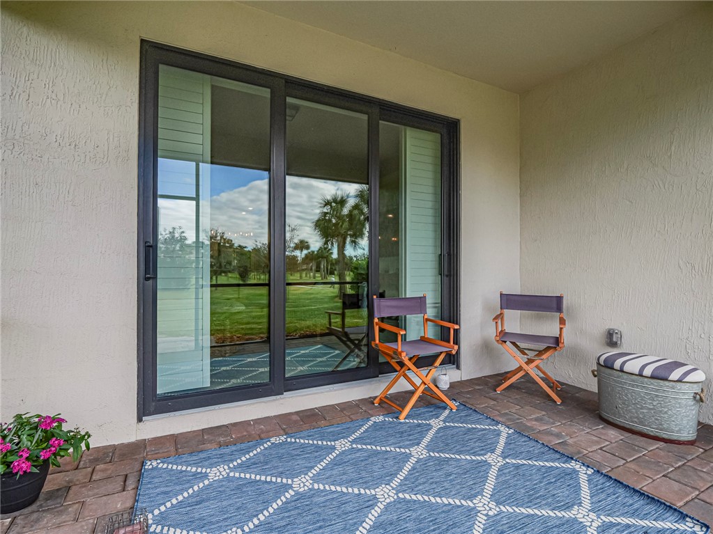 5190 Unity Square Vero Beach, FL 32967 - Photo 27 of 31 a living room with furniture and a floor to ceiling window