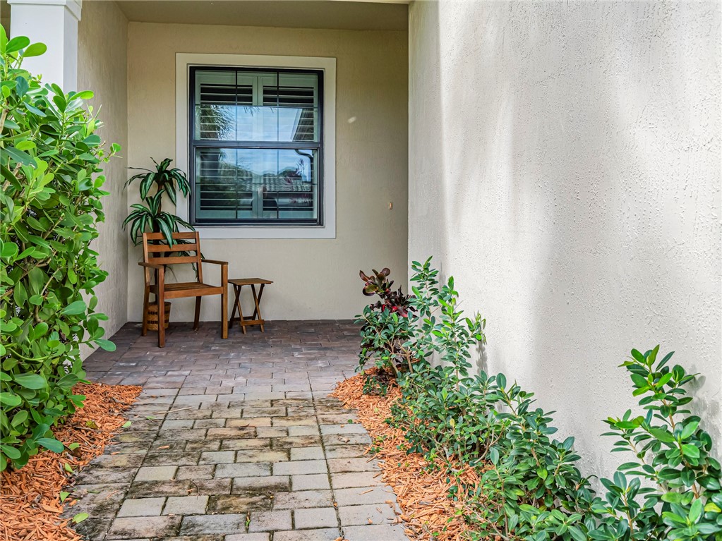5190 Unity Square Vero Beach, FL 32967 - Photo 4 of 31 a bench in a yard with potted plants