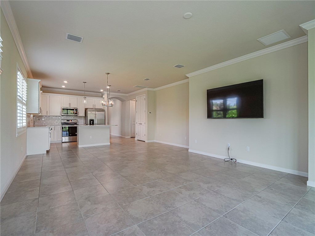 5190 Unity Square Vero Beach, FL 32967 - Photo 7 of 31 a view of a livingroom with furniture and a flat screen tv