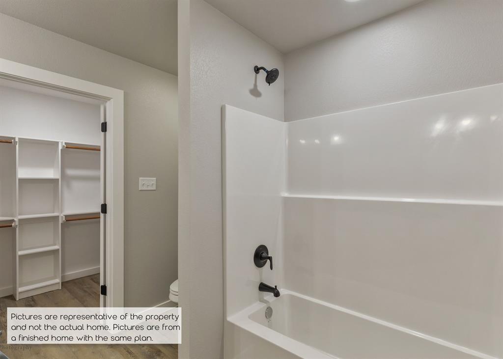 251 Tombstone Road Abilene, TX 79602 - Photo 17 of 27 a bathroom with a bathtub and a shower