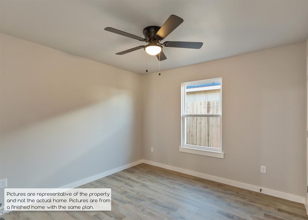 251 Tombstone Road Abilene, TX 79602 - Photo 22 of 27 a view of an empty room with wooden floor and a window