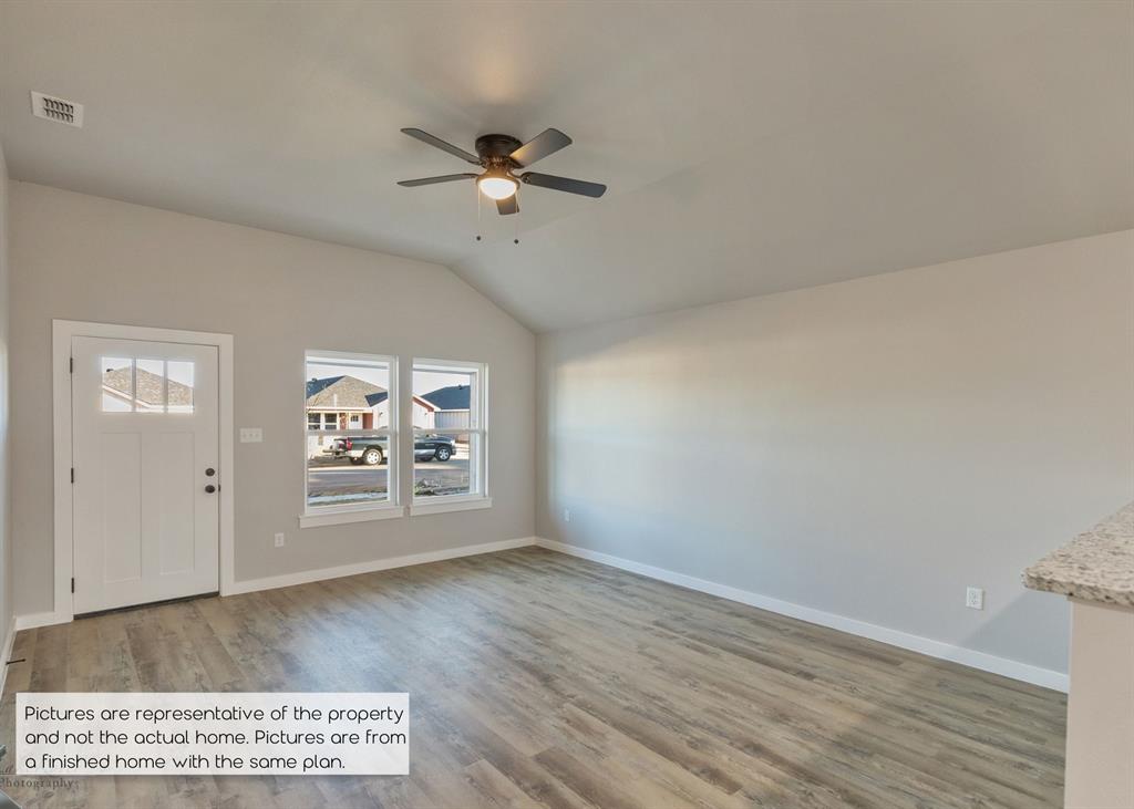 251 Tombstone Road Abilene, TX 79602 - Photo 4 of 27 a view of a big room with wooden floor and windows