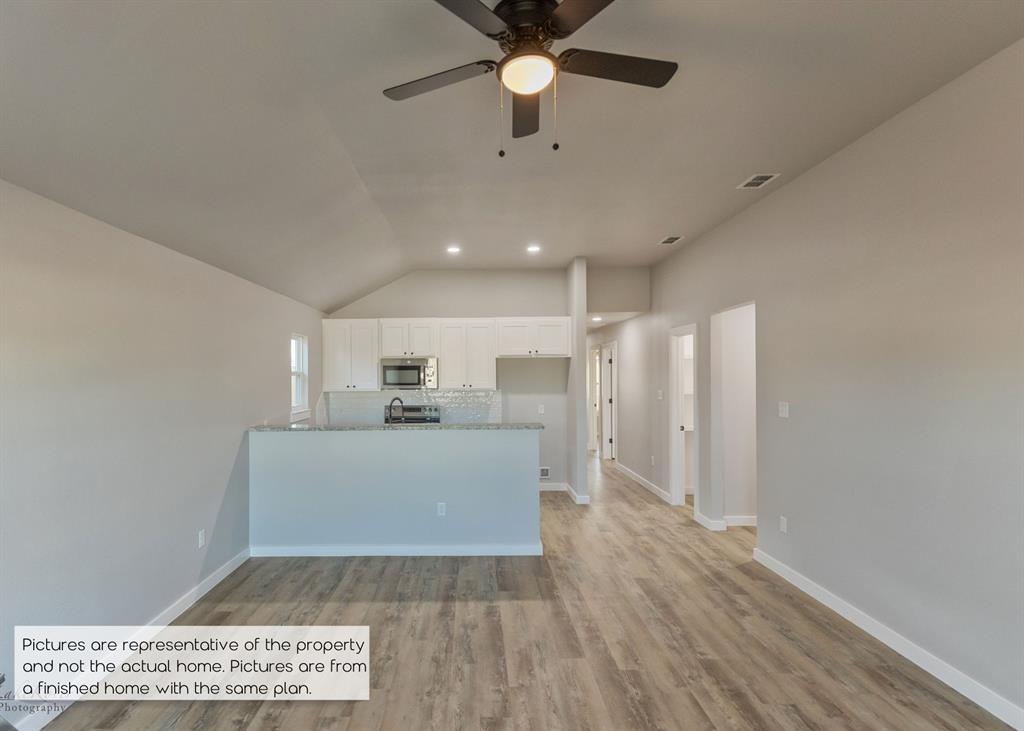 251 Tombstone Road Abilene, TX 79602 - Photo 7 of 27 a view of a kitchen with a sink and a refrigerator