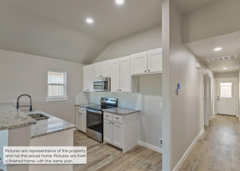 251 Tombstone Road Abilene, TX 79602 - Photo 8 of 27 a kitchen with granite countertop a sink cabinets and stainless steel appliances