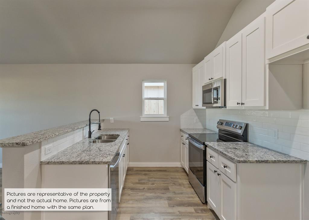 251 Tombstone Road Abilene, TX 79602 - Photo 9 of 27 a kitchen with granite countertop a sink stove and cabinets