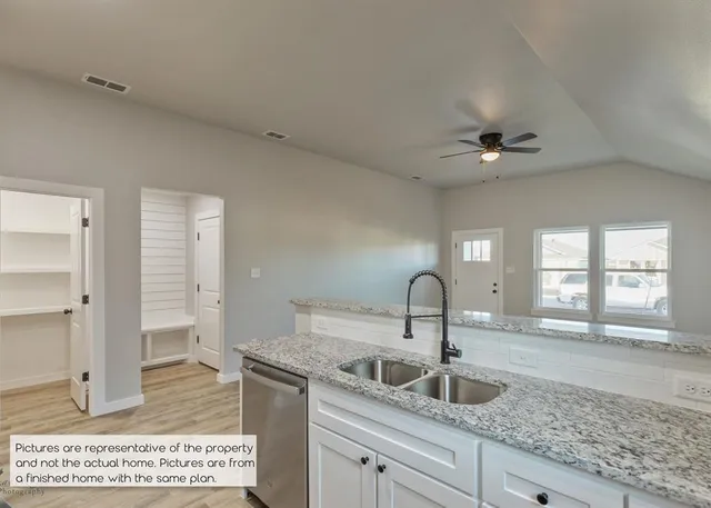 a kitchen with a sink and a refrigerator