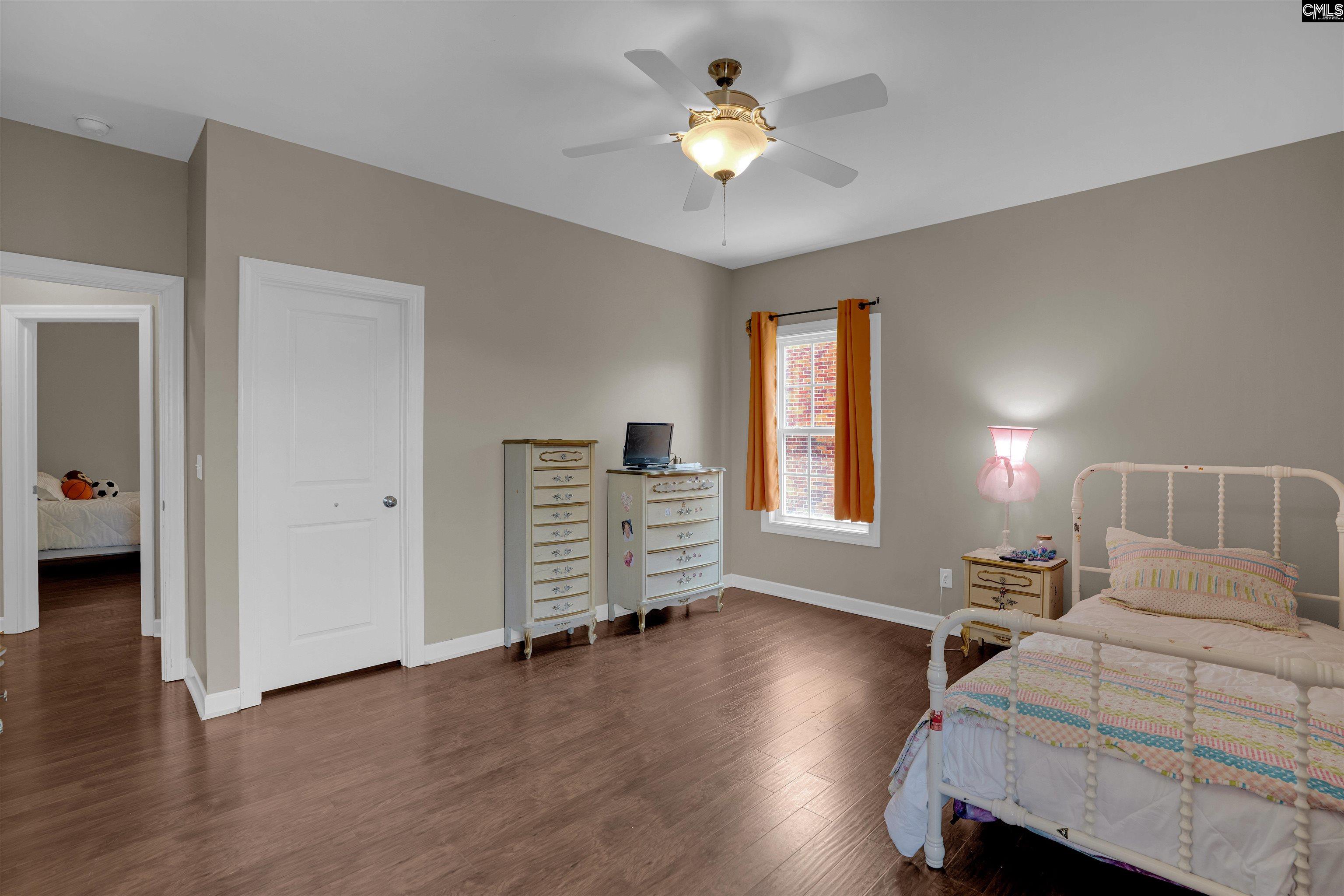 321 Asa Rose Lexington, SC 29072 - Photo 32 of 52 a view of a bedroom with wooden floor and a ceiling fan