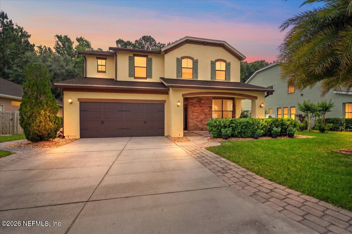 788 Reflection Cove Road East Jacksonville, FL 32218 - Photo 1 of 27 a front view of a house with a yard and garage
