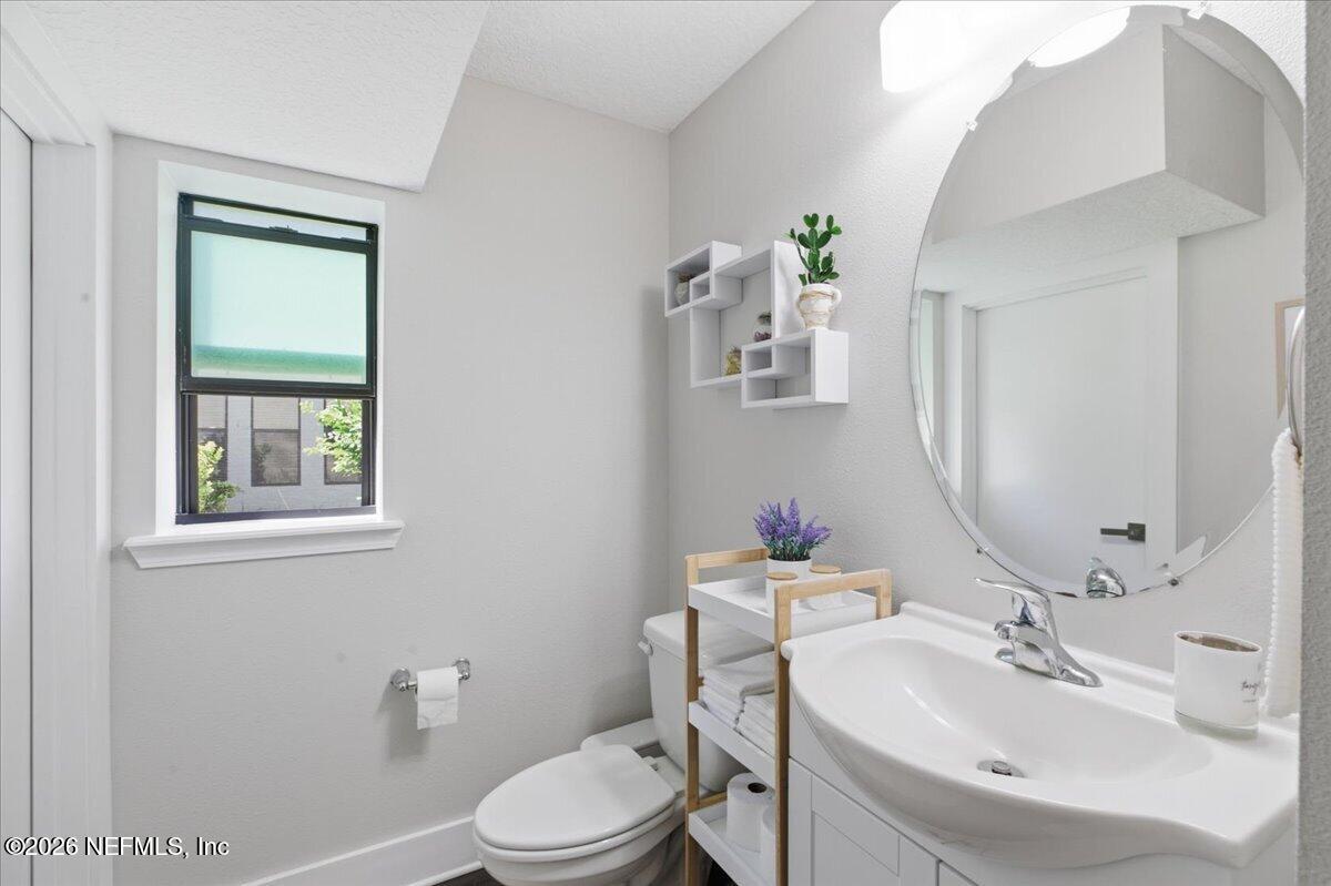 788 Reflection Cove Road East Jacksonville, FL 32218 - Photo 12 of 27 a bathroom with a sink a toilet and mirror