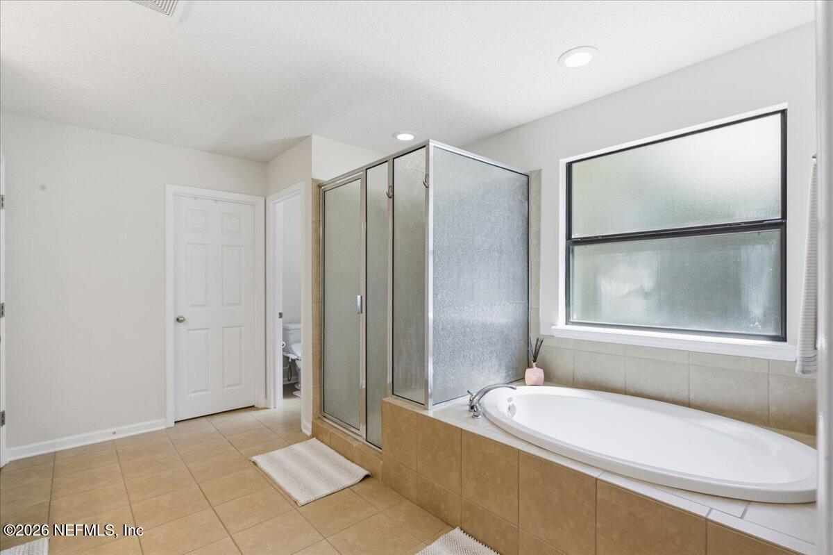 788 Reflection Cove Road East Jacksonville, FL 32218 - Photo 15 of 27 a bathroom with a bathtub and a shower