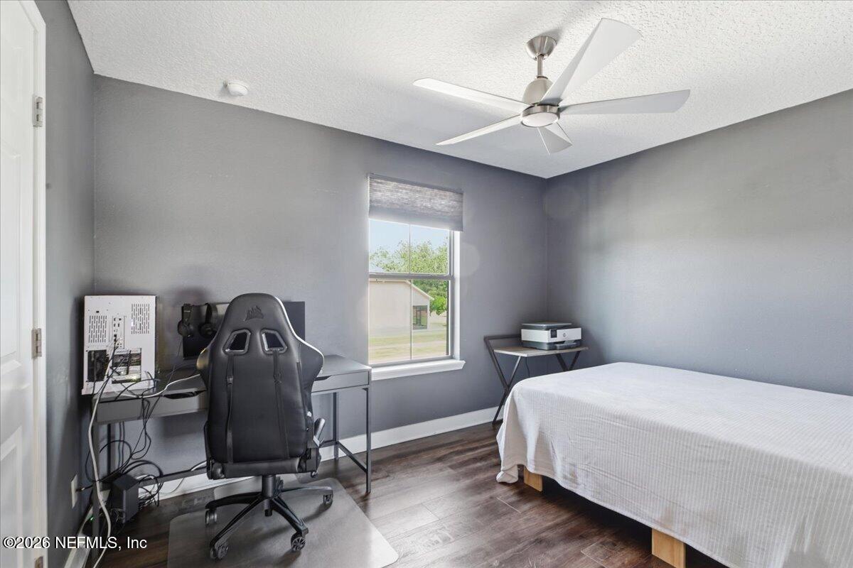 788 Reflection Cove Road East Jacksonville, FL 32218 - Photo 17 of 27 a bedroom with a bed and a chandelier