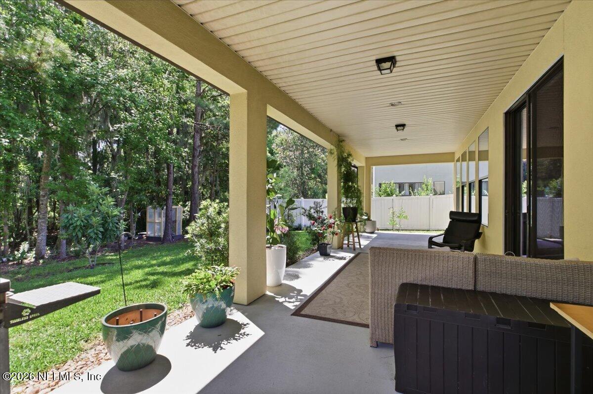 788 Reflection Cove Road East Jacksonville, FL 32218 - Photo 22 of 27 a view of a patio with chair and tables back yard of the house
