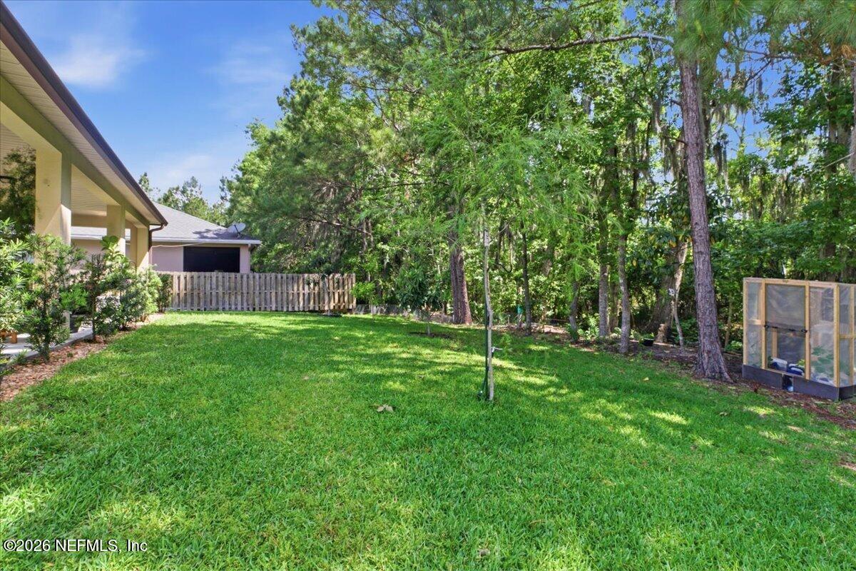 788 Reflection Cove Road East Jacksonville, FL 32218 - Photo 23 of 27 a view of a backyard with a garden