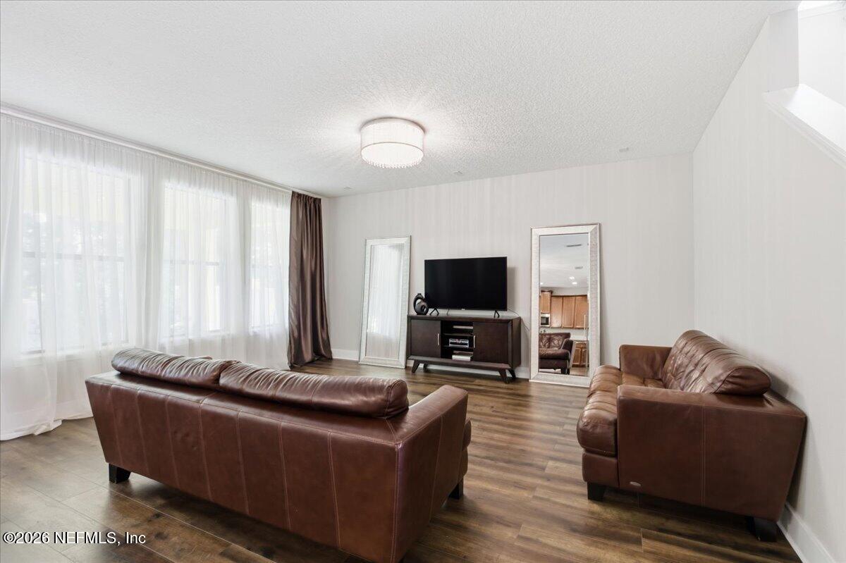 788 Reflection Cove Road East Jacksonville, FL 32218 - Photo 6 of 27 a living room with furniture and a flat screen tv