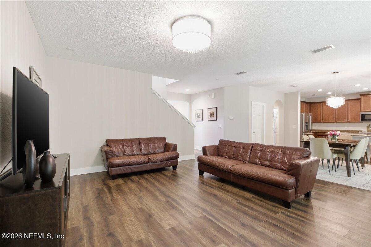 788 Reflection Cove Road East Jacksonville, FL 32218 - Photo 7 of 27 a living room with furniture and a flat screen tv