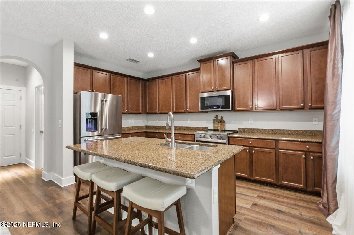 788 Reflection Cove Road East Jacksonville, FL 32218 - Photo 9 of 27 a kitchen with stainless steel appliances granite countertop a refrigerator stove microwave and sink