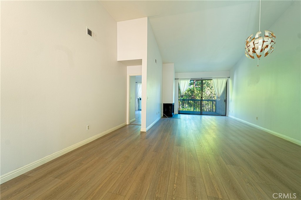 a view of room with window and wooden floor