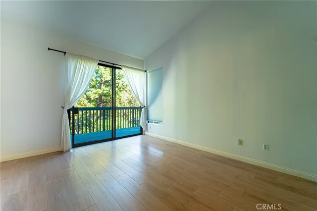 a view of a room with wooden floor and a window