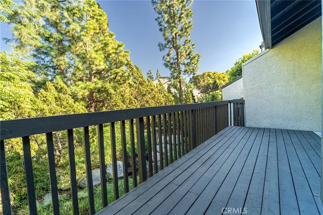 a view of a balcony with wooden floor
