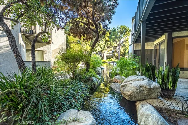 a view of a chairs and table in backyard