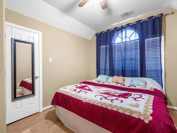 a bedroom with a bed and a mirror