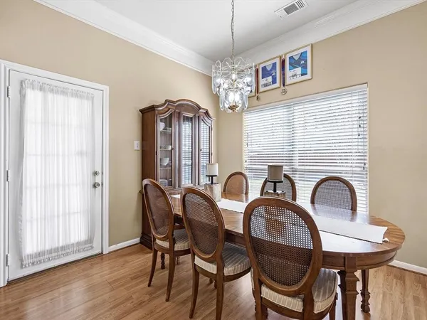 a dining room with furniture a chandelier and window
