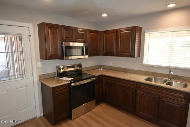 a kitchen with a sink stove and microwave