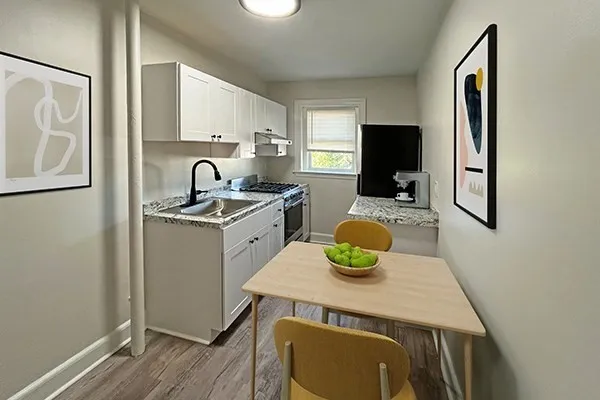 a kitchen with a sink a stove and chairs