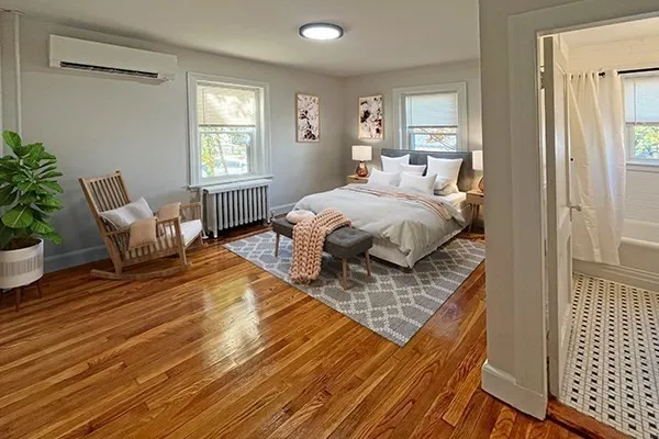 a spacious bedroom with a bed and window