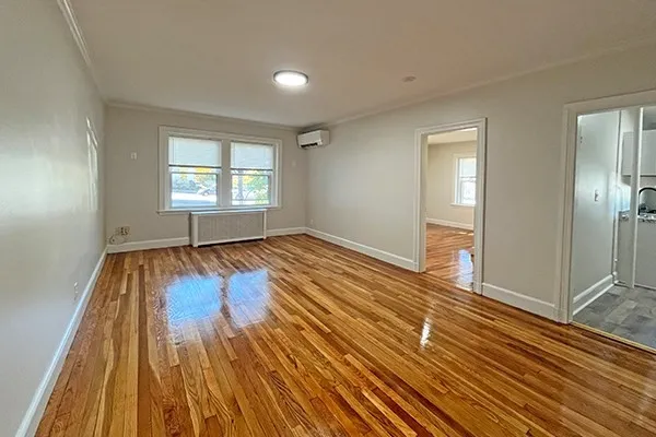 wooden floor in an empty room with a window