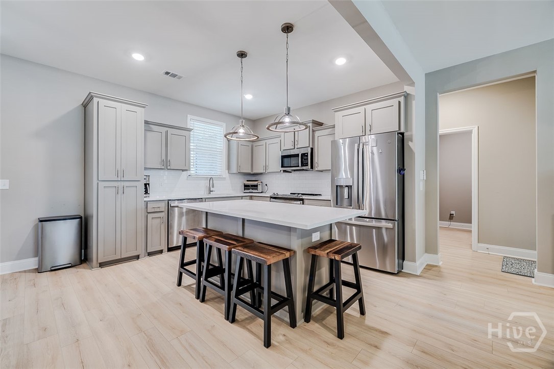 120 Sweetwater Circle Rincon, GA 31326 - Photo 11 of 48 Side facing, but still part of the great room, this is the perfect set up for this beautiful kitchen! with a large island!