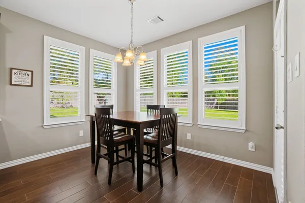 a living room with furniture and a projector screen