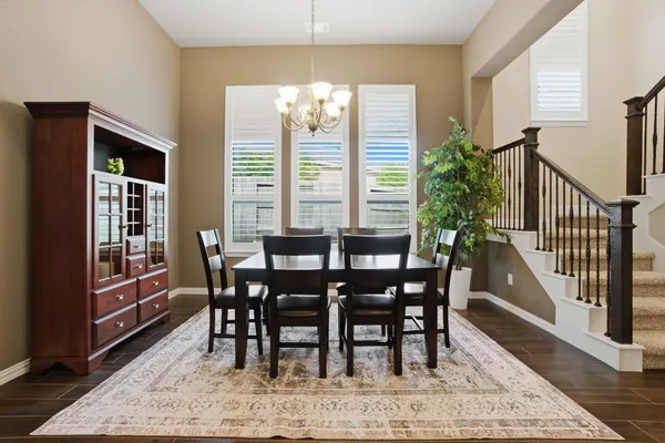 a living room with furniture a large window and a flat screen tv
