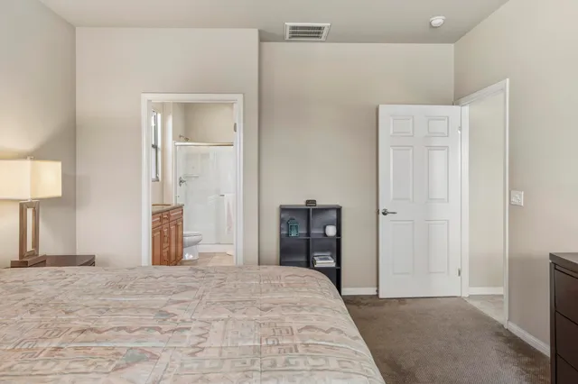 a bedroom with a bed and a lamp