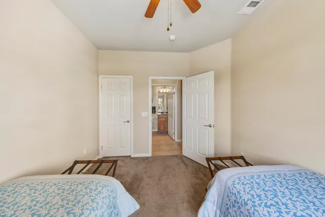 a bedroom with a bed and a lamp