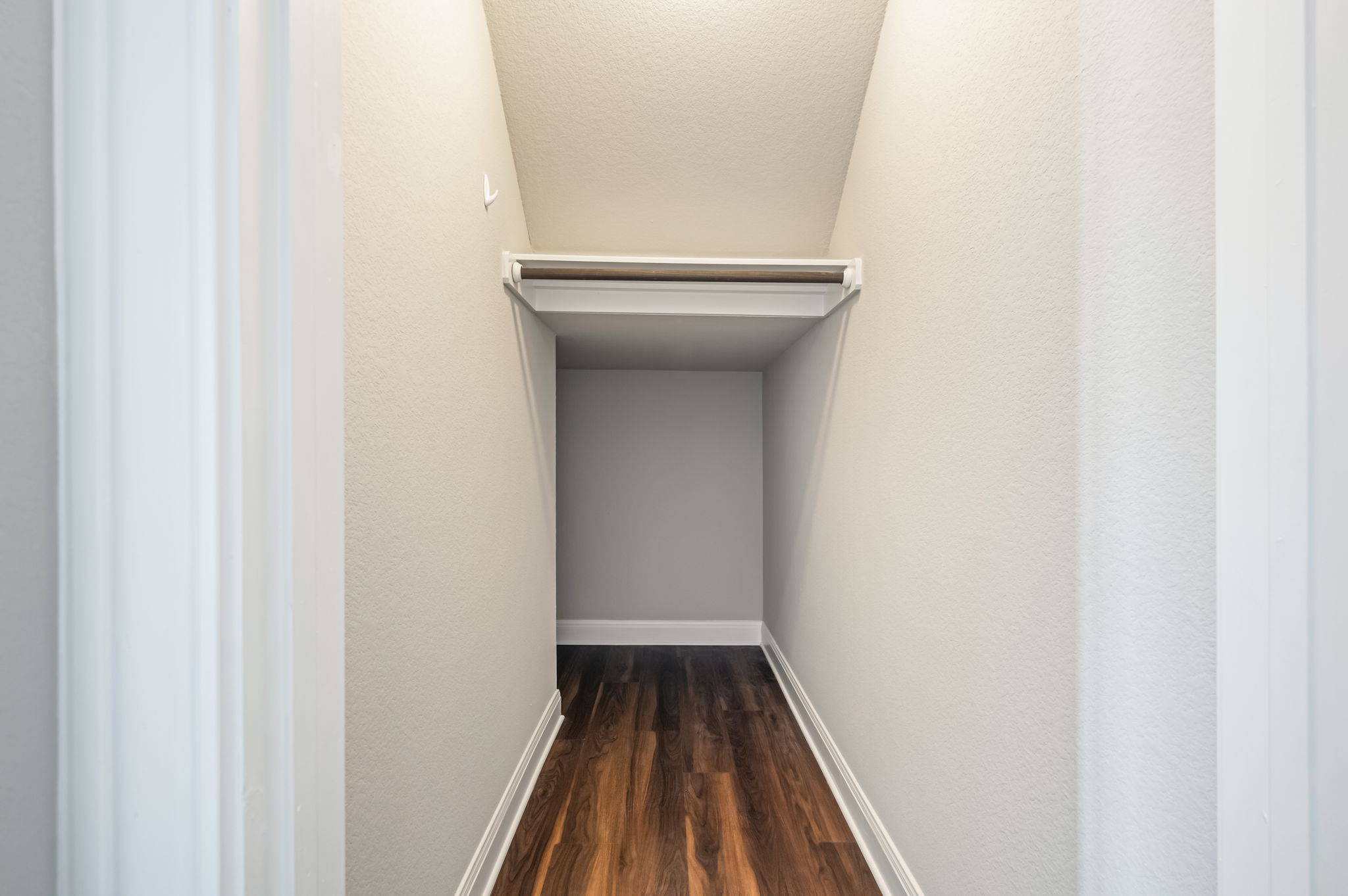 2516 Hopsack Mills Road Austin, TX 78748 - Photo 15 of 39 Closet storage featuring wood-finish flooring, a built-in shelf, and hanging rod