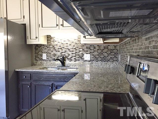 1608 Spennymore Road Raleigh, NC 27603 - Photo 14 of 25 a kitchen with a sink and granite counter tops