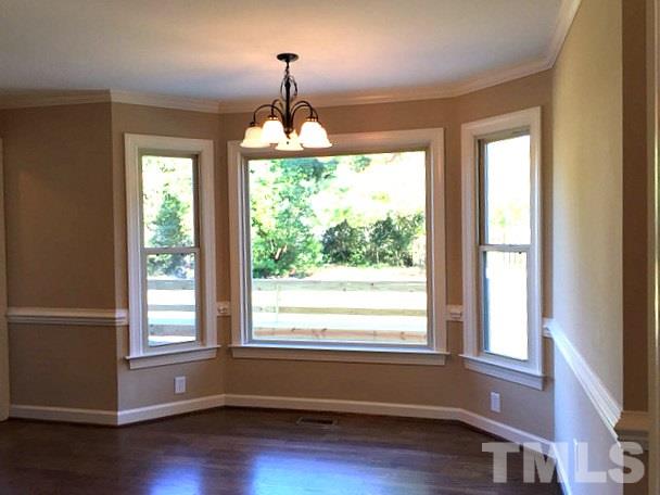 1608 Spennymore Road Raleigh, NC 27603 - Photo 15 of 25 a view of empty room with wooden floor and outdoor view