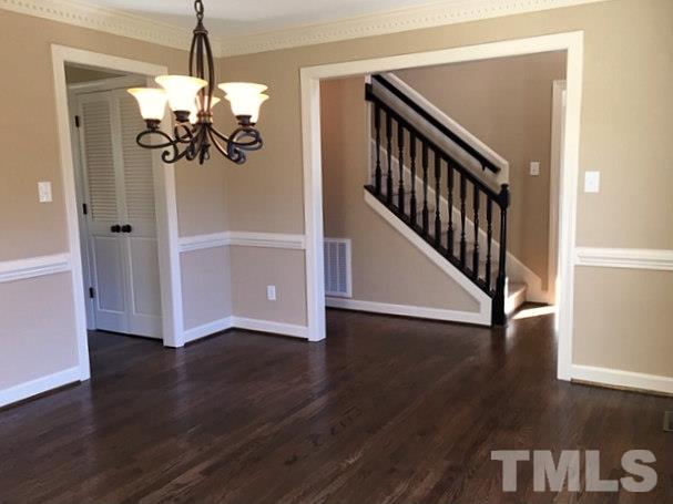 1608 Spennymore Road Raleigh, NC 27603 - Photo 16 of 25 a view of a hallway with wooden floor and staircase